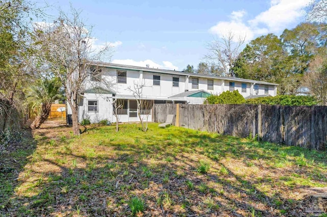 back of property with a fenced backyard