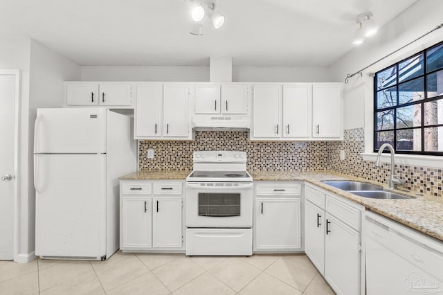 kitchen featuring under cabinet range hood, white appliances, a sink, white cabinets, and backsplash