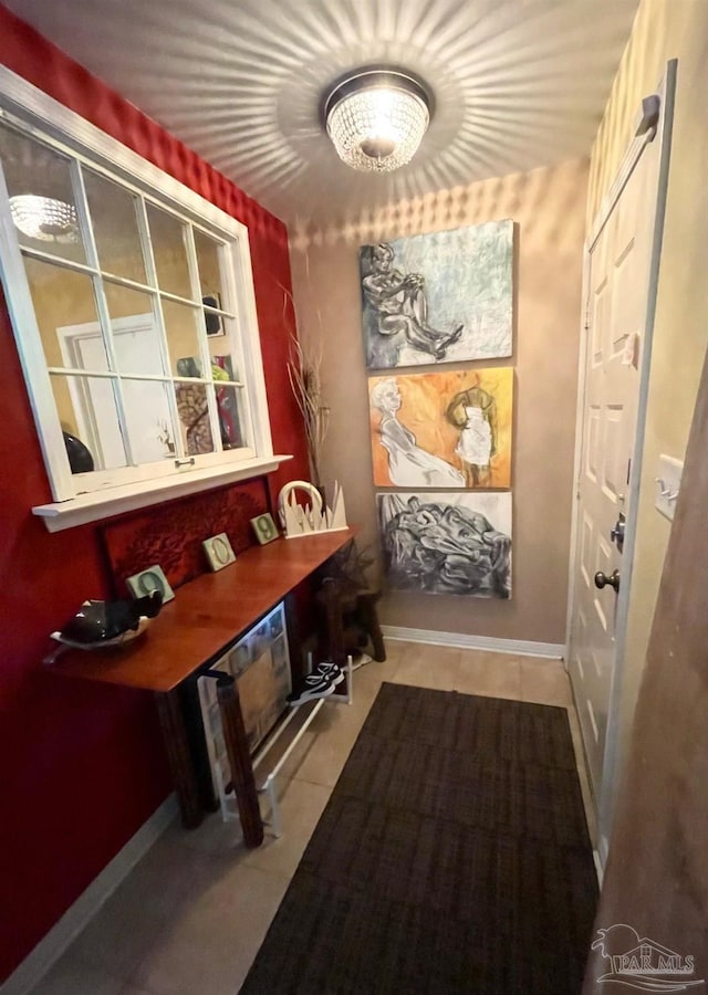 interior space with baseboards and tile patterned floors