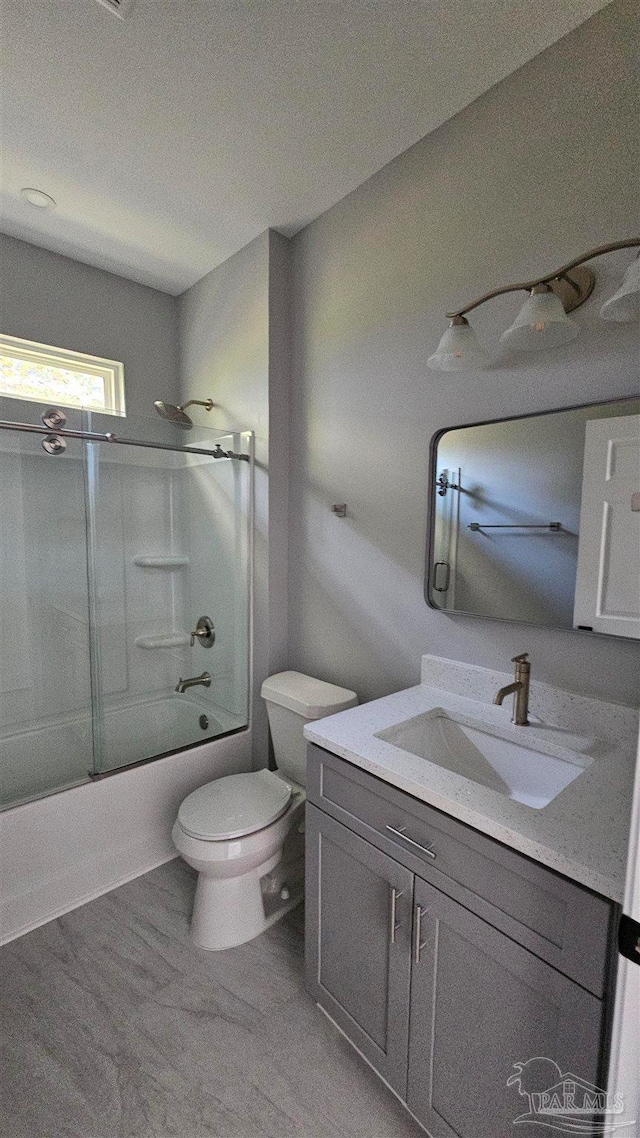 full bathroom with vanity, enclosed tub / shower combo, and toilet