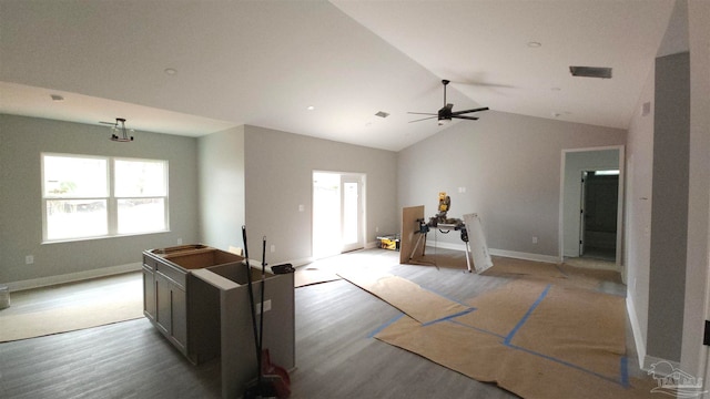 interior space featuring ceiling fan, vaulted ceiling, and light wood-type flooring