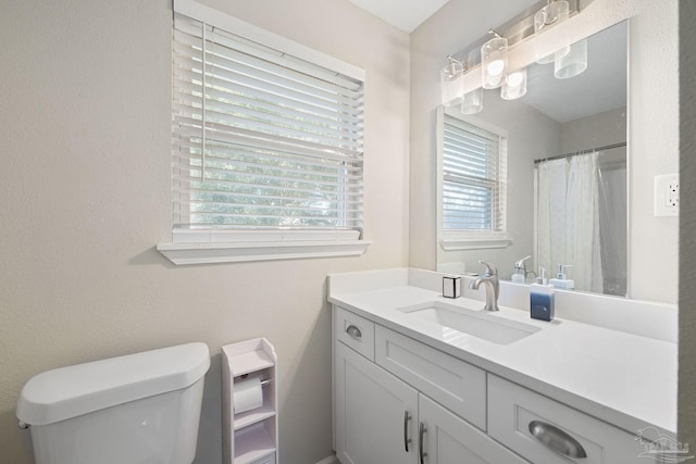 bathroom featuring toilet and vanity