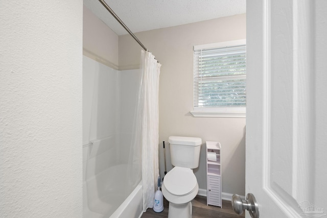 bathroom with hardwood / wood-style flooring, a textured ceiling, toilet, and shower / bath combination with curtain