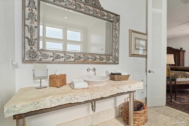 1220 State Highway 180, Gulf Shores, AL 36542 - bathroom featuring brick patterned flooring, crown molding, vanity, and connected bathroom