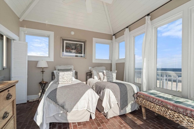 1220 State Highway 180, Gulf Shores, AL 36542 - bedroom with vaulted ceiling, brick floors, and baseboards