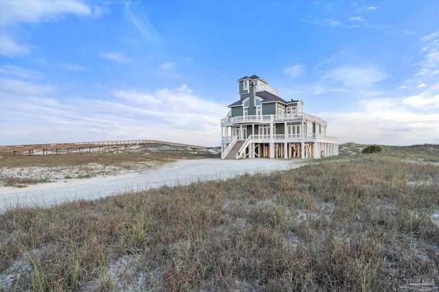 1220 State Highway 180, Gulf Shores, AL 36542 - back of property featuring driveway, a carport, and a balcony