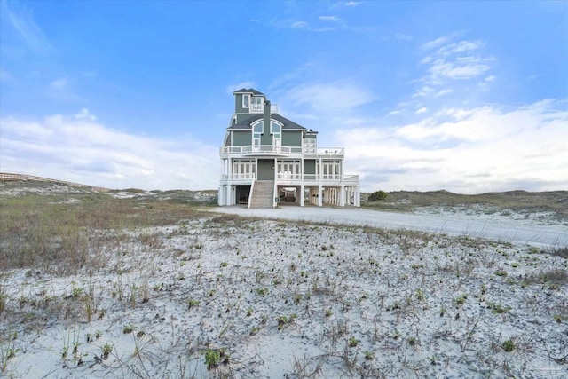1220 State Highway 180, Gulf Shores, AL 36542 - rear view of property with stairs and a balcony