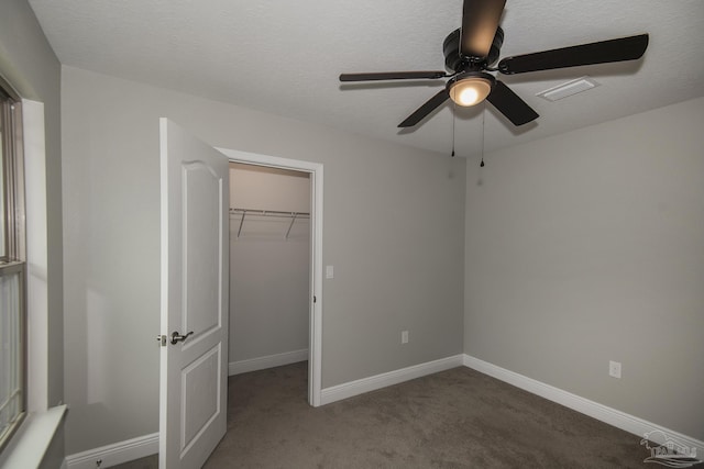 3620 Ranch Dr, Crestview, FL 32539 - unfurnished bedroom with a walk in closet, carpet, a closet, baseboards, and a ceiling fan