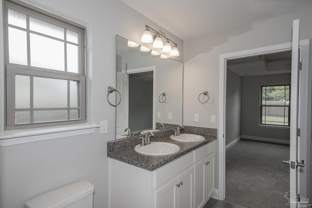 3620 Ranch Dr, Crestview, FL 32539 - bathroom featuring toilet, double vanity, and baseboards