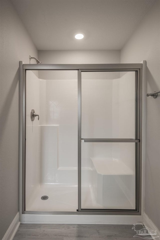 3620 Ranch Dr, Crestview, FL 32539 - bathroom with baseboards, a stall shower, and wood finished floors