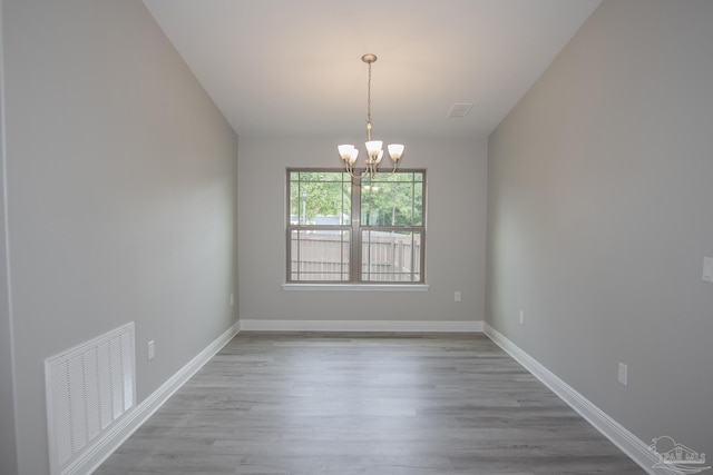 3620 Ranch Dr, Crestview, FL 32539 - spare room with a chandelier, wood finished floors, and baseboards