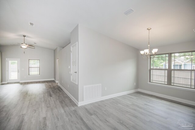 3620 Ranch Dr, Crestview, FL 32539 - spare room featuring lofted ceiling, light wood-type flooring, healthy amount of natural light, a chandelier, and baseboards