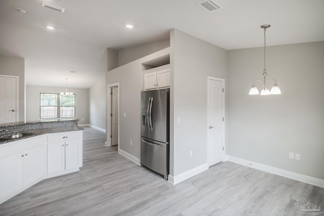3620 Ranch Dr, Crestview, FL 32539 - kitchen featuring stainless steel fridge, a chandelier, white cabinets, light wood-style floors, and a sink
