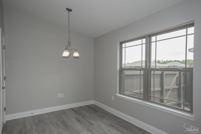 3620 Ranch Dr, Crestview, FL 32539 - empty room with a chandelier, wood finished floors, and baseboards