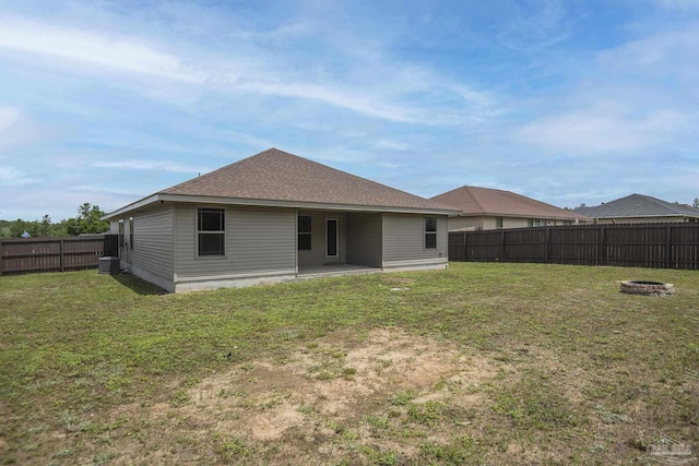 3620 Ranch Dr, Crestview, FL 32539 - back of property featuring a fire pit, a patio, and a shingled roof
