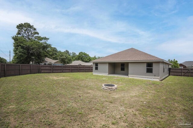 3620 Ranch Dr, Crestview, FL 32539 - rear view of house featuring a fire pit and a shingled roof