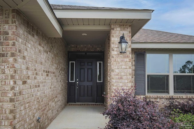 3620 Ranch Dr, Crestview, FL 32539 - view of exterior entry with roof with shingles and brick siding