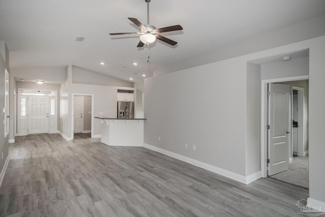 3620 Ranch Dr, Crestview, FL 32539 - unfurnished living room with a ceiling fan, light wood-style flooring, lofted ceiling, baseboards, and recessed lighting