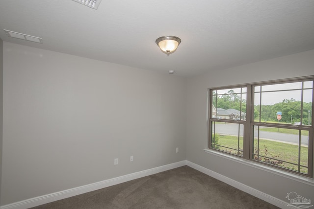 3620 Ranch Dr, Crestview, FL 32539 - empty room featuring dark colored carpet and baseboards