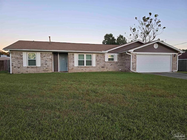 single story home with a yard and a garage