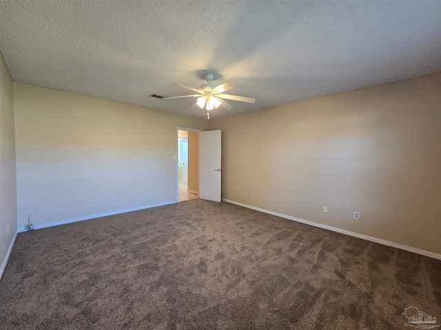 spare room with a textured ceiling, carpet flooring, and ceiling fan