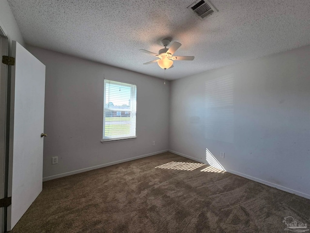 unfurnished room with dark carpet, a textured ceiling, and ceiling fan