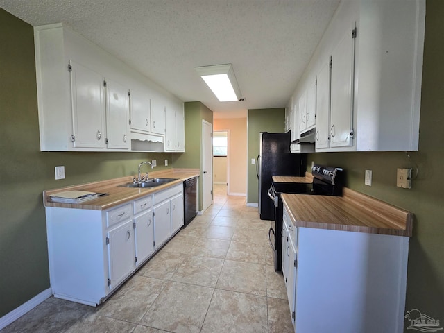 kitchen with white cabinetry, black appliances, sink, and a textured ceiling