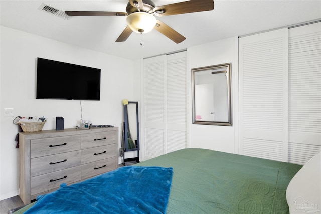 bedroom featuring multiple closets and ceiling fan