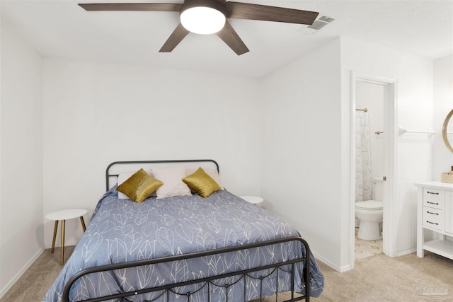 carpeted bedroom featuring ceiling fan and ensuite bath