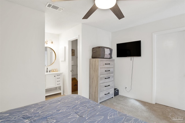 unfurnished bedroom featuring ceiling fan, light colored carpet, and connected bathroom