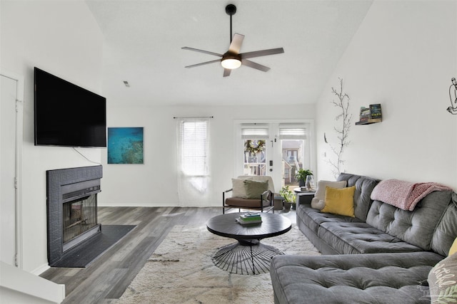 living room with dark wood-type flooring, high vaulted ceiling, french doors, and ceiling fan