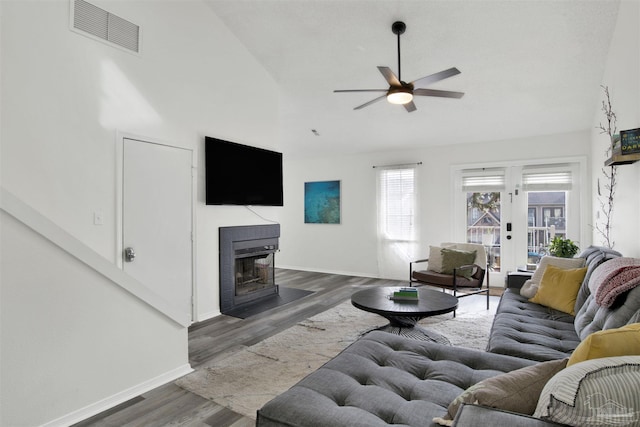 living room featuring ceiling fan, high vaulted ceiling, and dark hardwood / wood-style flooring