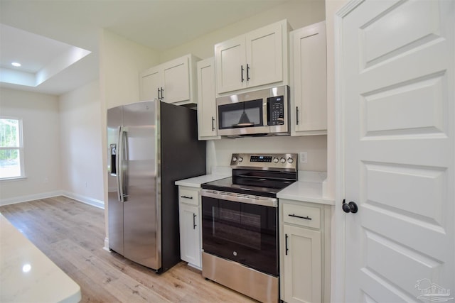 5742 San Blas St, Milton, FL 32583 - kitchen with appliances with stainless steel finishes, light wood finished floors, light countertops, white cabinets, and recessed lighting