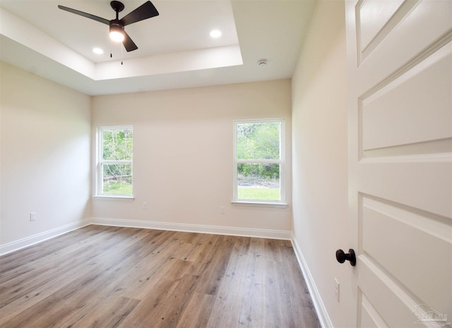 5742 San Blas St, Milton, FL 32583 - unfurnished room with light wood finished floors, recessed lighting, a ceiling fan, baseboards, and a raised ceiling
