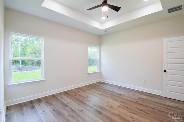 5742 San Blas St, Milton, FL 32583 - unfurnished room featuring a raised ceiling, baseboards, wood finished floors, a ceiling fan, and recessed lighting