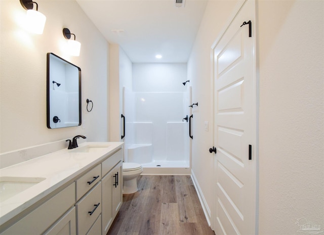 5742 San Blas St, Milton, FL 32583 - bathroom featuring a shower stall, wood finished floors, toilet, double vanity, and recessed lighting