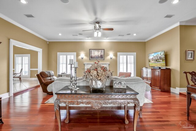 dining area featuring ornamental molding, wood-type flooring, and a wealth of natural light