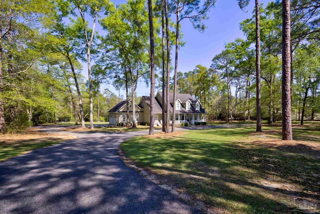 new england style home featuring a front lawn