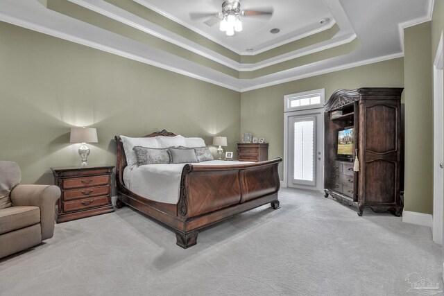 bedroom with ornamental molding, access to outside, ceiling fan, a raised ceiling, and light carpet