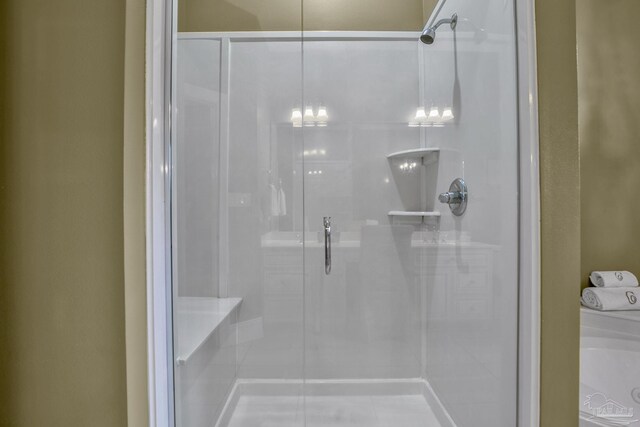 bathroom with an enclosed shower and washer / dryer