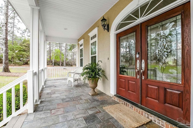 property entrance with french doors and a porch