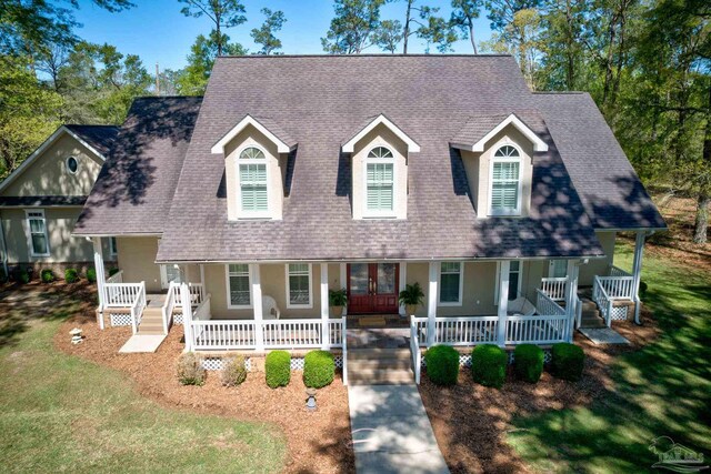 cape cod-style house with french doors, a porch, and a front yard