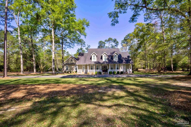 cape cod house with a front yard and covered porch