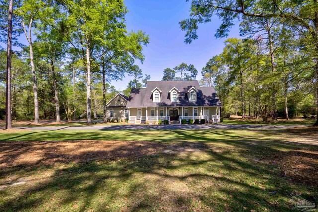 cape cod house with a front yard and covered porch