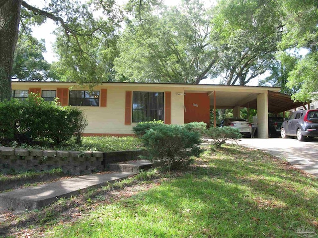 view of front facade with a carport and a front lawn