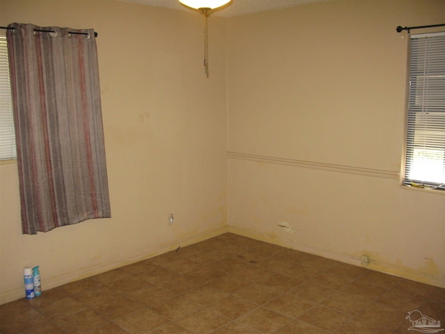 empty room with tile patterned flooring