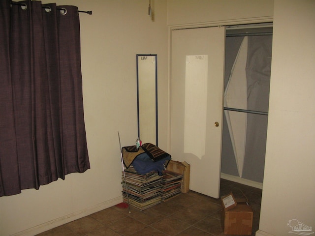 spacious closet with dark tile patterned floors