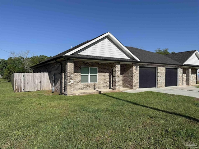 9901 Raymar St Unit A, Pensacola, FL 32534 - view of front of house featuring an attached garage, fence, concrete driveway, brick siding, and a front lawn