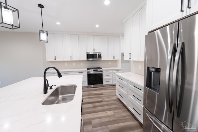 9901 Raymar St Unit A, Pensacola, FL 32534 - kitchen with recessed lighting, white cabinets, stainless steel appliances, a sink, and wood finished floors