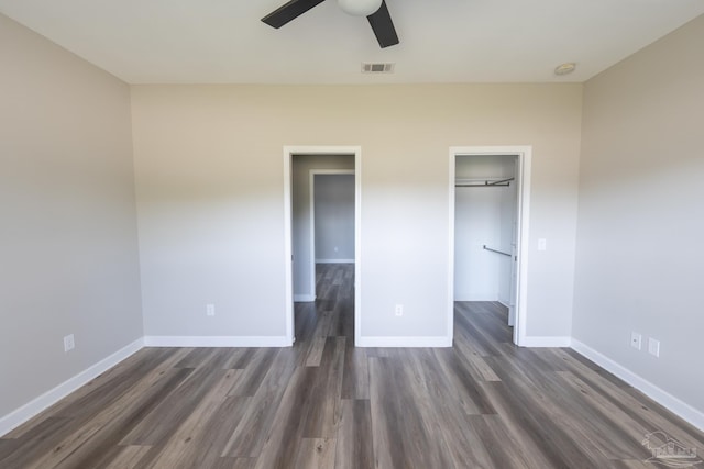 9901 Raymar St Unit A, Pensacola, FL 32534 - unfurnished bedroom featuring dark wood-type flooring, baseboards, a spacious closet, and visible vents
